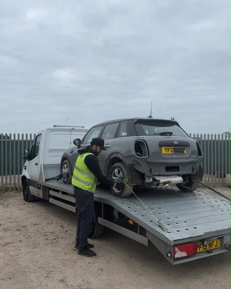 Mini being winched onto flatbed